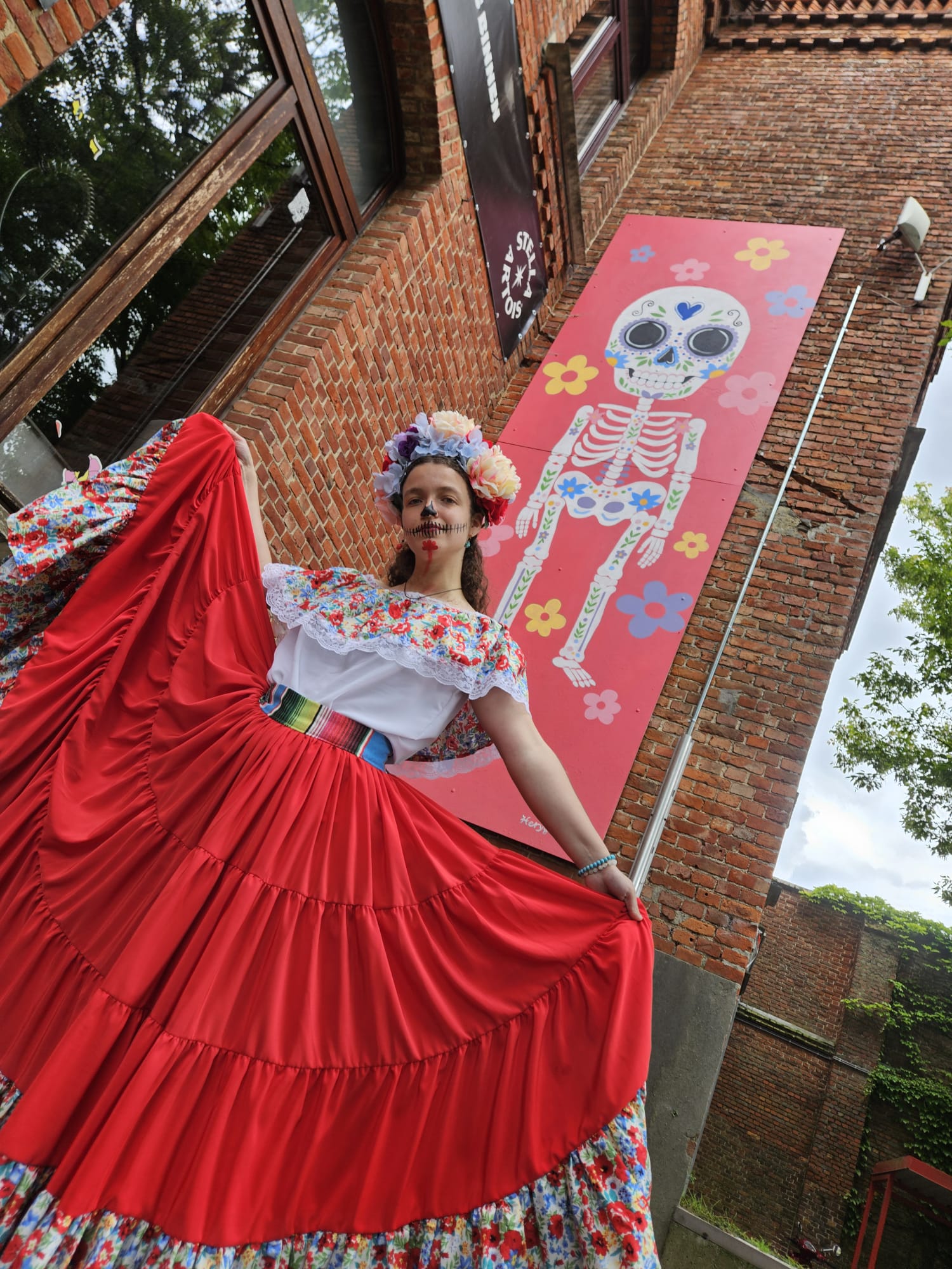 artist with mural in background